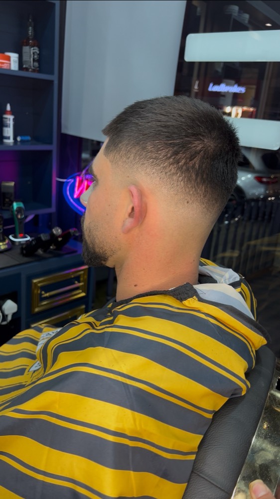 A fresh skin fade finished at Aaron Barber, clean blend into the neckline