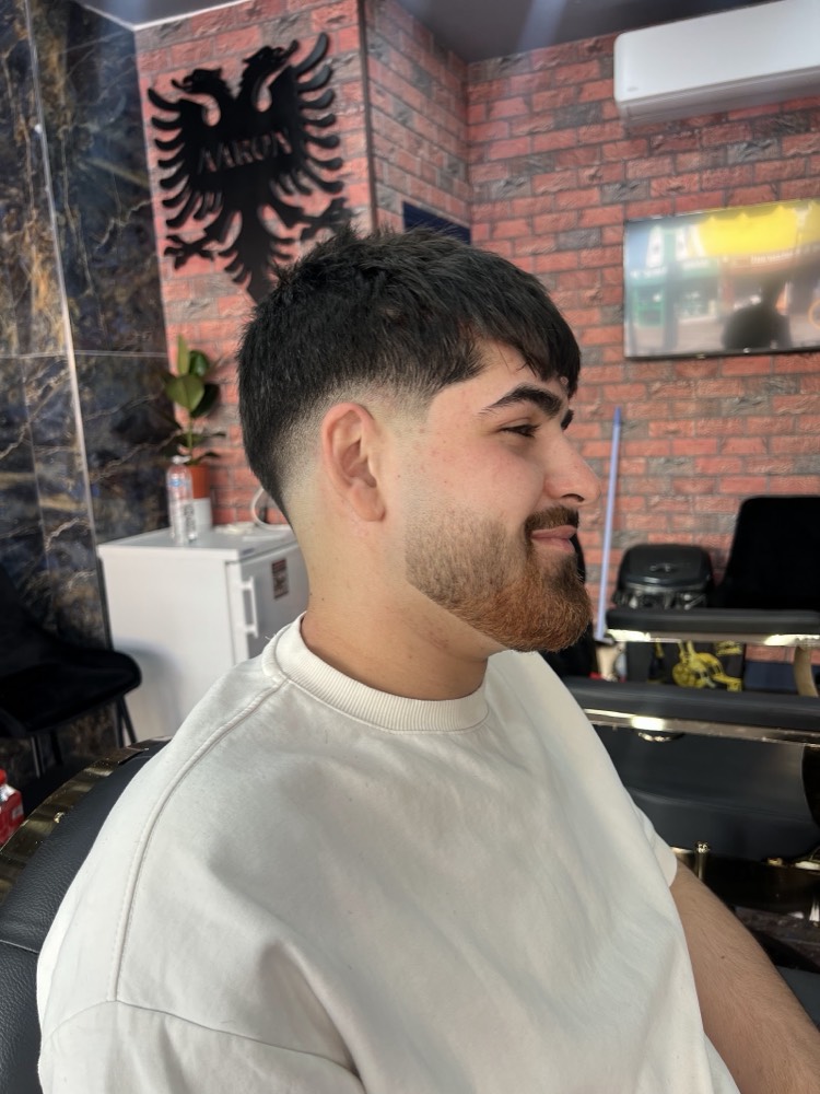 A textured crop with a fade and shaped beard finished at Aaron Barber